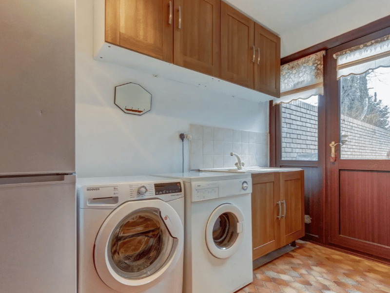A small area tucked away for laundry, creating more room elsewhere