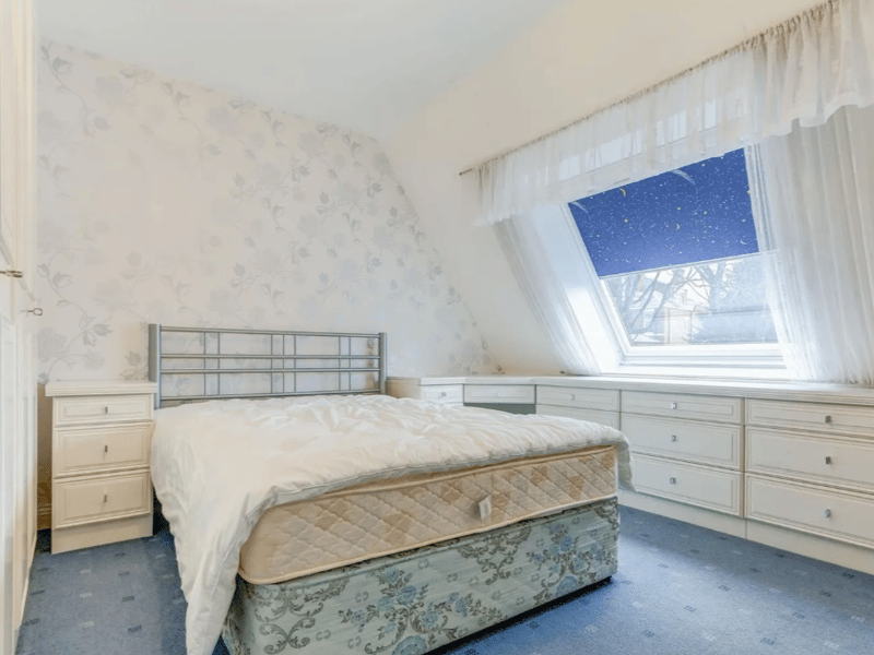 One of three bedrooms seen here, with a lovely slanted window