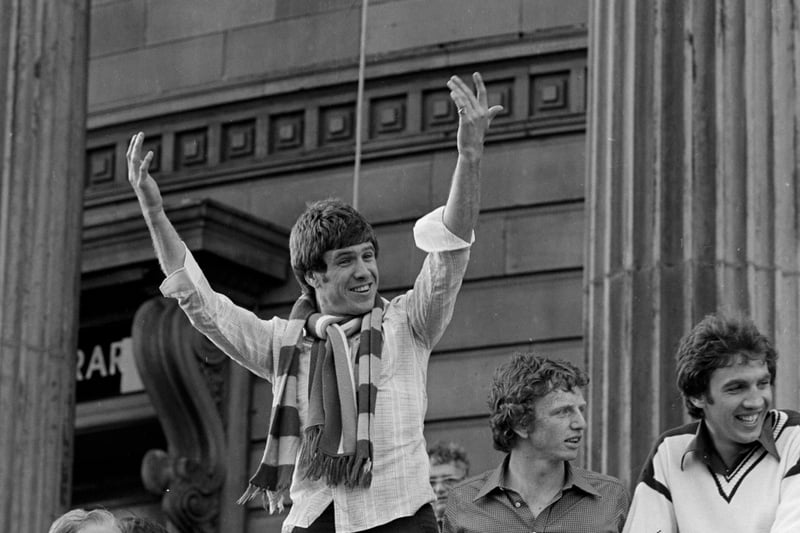 Liverpool captain Emlyn Hughes starts to conduct the fans singing of You’ll Never Walk Alone as the team celebrate winning the European Cup outside Picton Library.