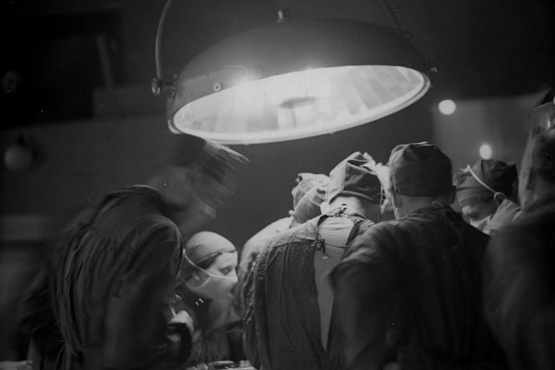 1938:  Surgeons at work in the operating theatre of St Bartholomew's Hospital in London.  (Photo by London Express/Getty Images)