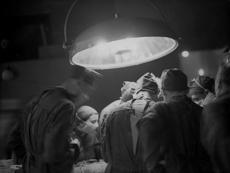 1938: Surgeons at work in the operating theatre of St Bartholomew's Hospital in London. (Photo by London Express/Getty Images)