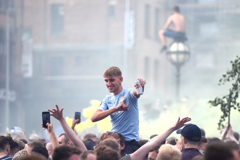Leeds United fans celebrate after winning the Sky Bet Championship title at Millennium Square 