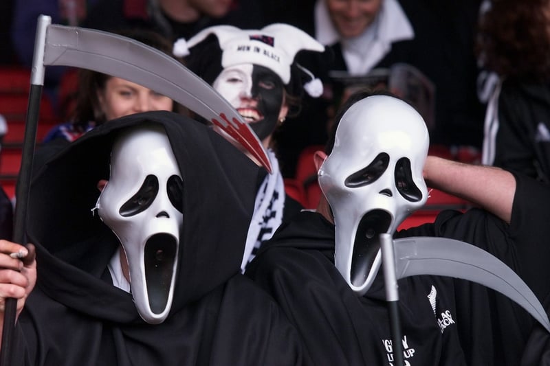 New Zealand’s fans disguised in Scream masks support their team during the first-round Rugby World Cup match between New Zealand and Tonga at the Ashton Gate stadium in Bristol 03 October 1999