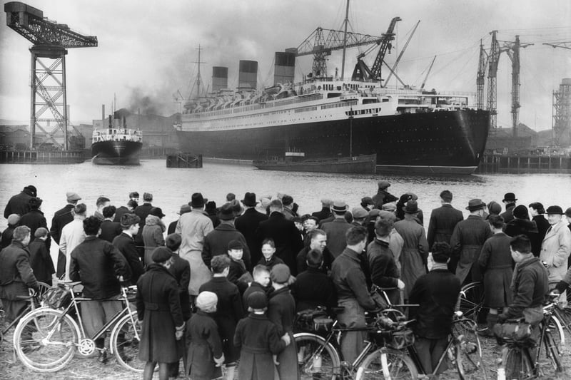 A crowd admires the nearly completed Cunard White Star liner Queen Mary at Clydebank. The launch of a ship would always draw in crowds of Glaswegians, keen to see their family and friends handiwork