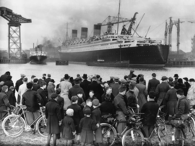 A crowd admires the nearly completed Cunard White Star liner Queen Mary at Clydebank. The launch of a ship would always draw in crowds of Glaswegians, keen to see their family and friends handiwork