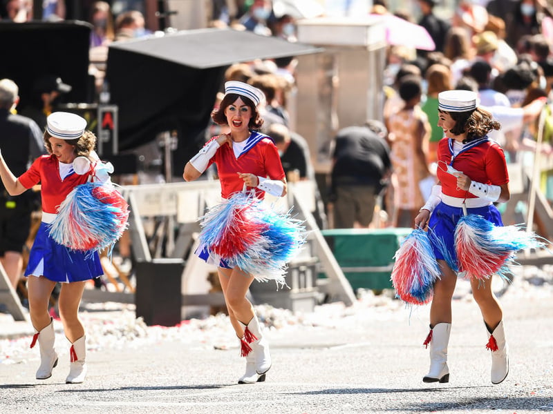 Extras dressed up as cheerleaders to hype up the parade in 60s America (Photo by Jeff J Mitchell/Getty Images)
