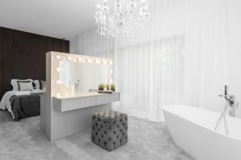 A second bedroom also features a tub and a glamorous dressing table.