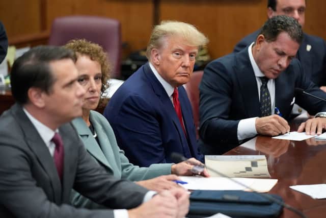  Former U.S. President Donald Trump sits at the defense table with his defense team in a Manhattan court (Photo by Seth Wenig-Pool/Getty Images)