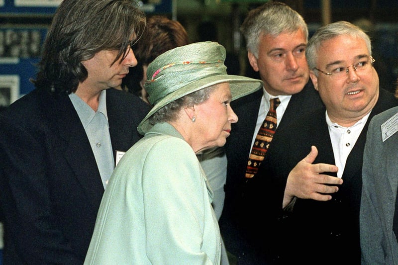 The Queen meets Michael ‘Sinbad’ Starke from the TV soap Brookside at Liverpool Central Library, accompanied by Phil Redmond.