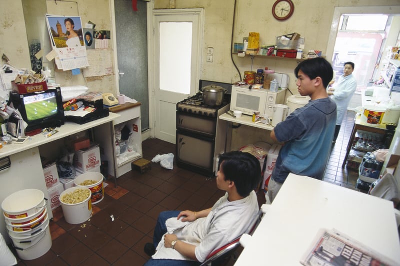 Staff at a Chinese takeaway in Liverpool watch a match on television during the 1996 European Championships.