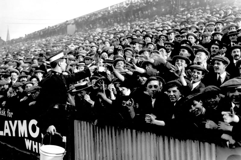 An ambulance worker hands out water at a match between Tottenham Hotspur and Manchester City at White Hart Lane on September 27 1913.  (Photo by Topical Press Agency/Getty Images)