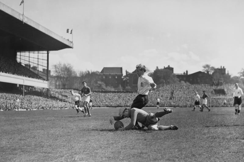 Julien Darui (1916 - 1987), goalkeeper for France dives in an attempt to stop Wilf Mannion (1918 - 2000), inside forward for England from scoring. England won the match 3 - 0. 