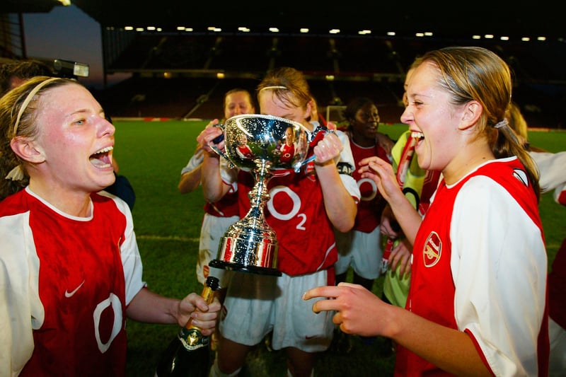 Kirsty Pealling and Jo Potter of Arsenal celebrate winning the Premiership as their captain Faye White drinks champagne from the trophy during the Nationwide Womens Premiership match between Arsenal and Fulham at Highbury.