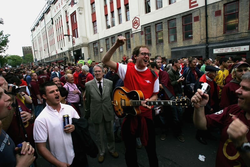 Arsenal fans sing as they arrive to watch the Barclays Premiership match between Arsenal and Wigan Athletic at Arsenall Highbury Football stadium on May 7, 2006. The match is the last to be played at Highbury after 93 years, as next season Arsenal will kick off nearby at the new Emirates Stadium.