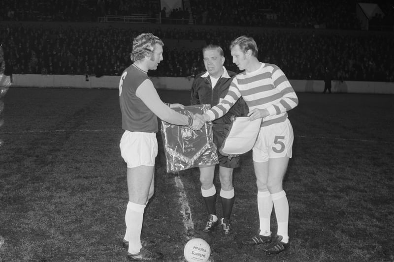 West Ham captain Bobby Moore pictured (L) exchanging pennants with Celtic skipper Billy McNeill prior to a testimonial match at the Boleyn Ground in Upton Park, London in November 1970