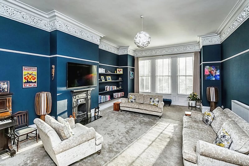 Living Room - Bespoke sash wooden framed windows, original ornate coving, carpeted flooring, radiator, victorian fireplace.