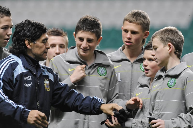 The Argentinian legend led his first training session as international boss at Celtic Park in November 2008. Here he is pictured alongside some waiting youth players at the club. 