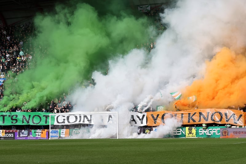 Celtic fans display the Irish flag in green, white and orange smoke bombs with a banner captioned ‘It’s not going away you know’ 