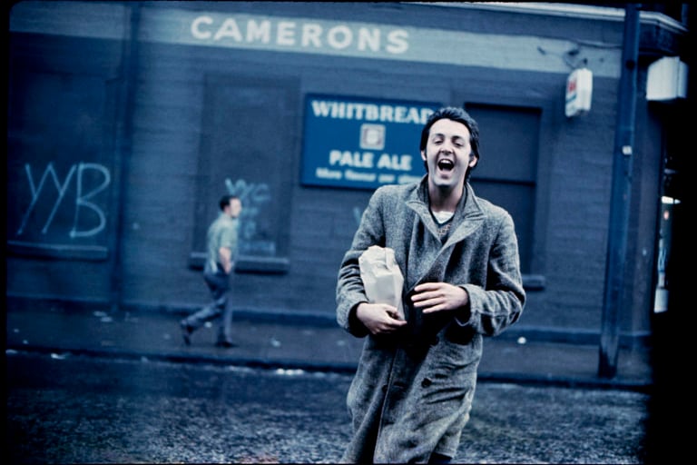 Former Beatle Paul McCartney crosses the road outside Camerons bar in Glasgow which is now The Carnarvon Bar. 
