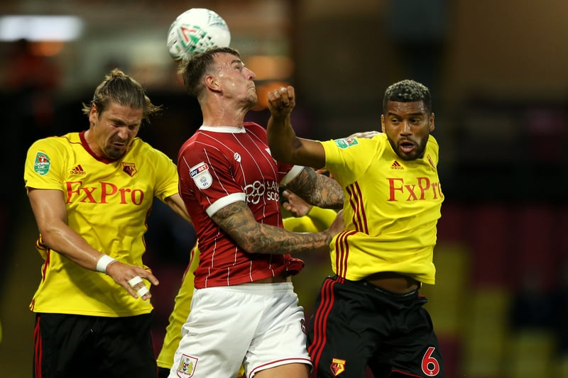 The towering presence of Flint dealing with several Watford players.
