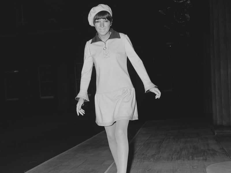 Jersey dresses were a key part of Quant’s 1963 autumn/winter collection. She realised that jersey was a cheaper material than wool, which was commonly used at the time, and also that it provided a great level of stretch and also structure which helped her to create her fitted designs. Quant herself is pictured wearing a cream and navy jersey dress to receive her OBE from the Queen in November 1966.