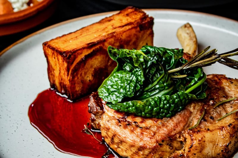 Bone In Pork Chop with Crispy Potato Cake served up with Cavolo Nero and Jus