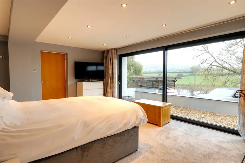 The master bedroom on the ground floor enjoys fine views with an en suite dressing room and shower room.
