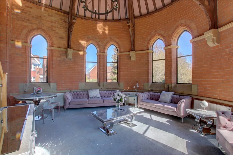 Living room with large vaulted windows where the altar used to be.