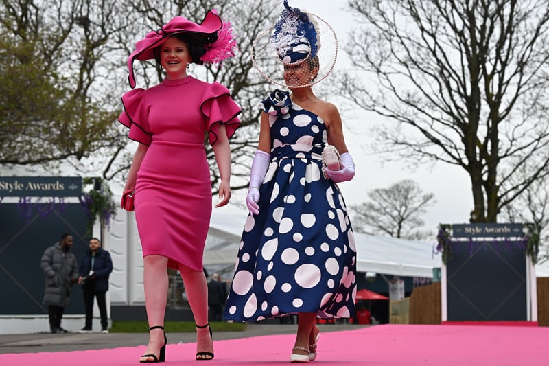 Two racegoers arrive at Aintree on Friday.