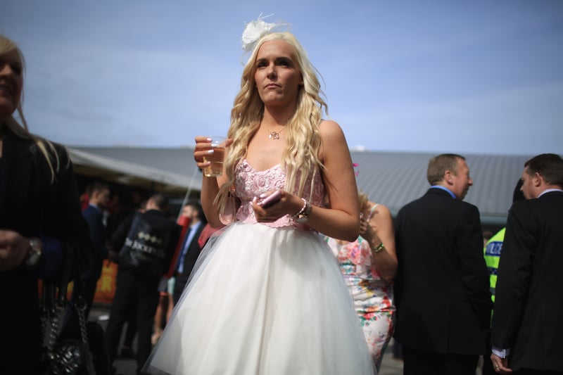 One racegoer enjoys a drink at Aintree in 2016.