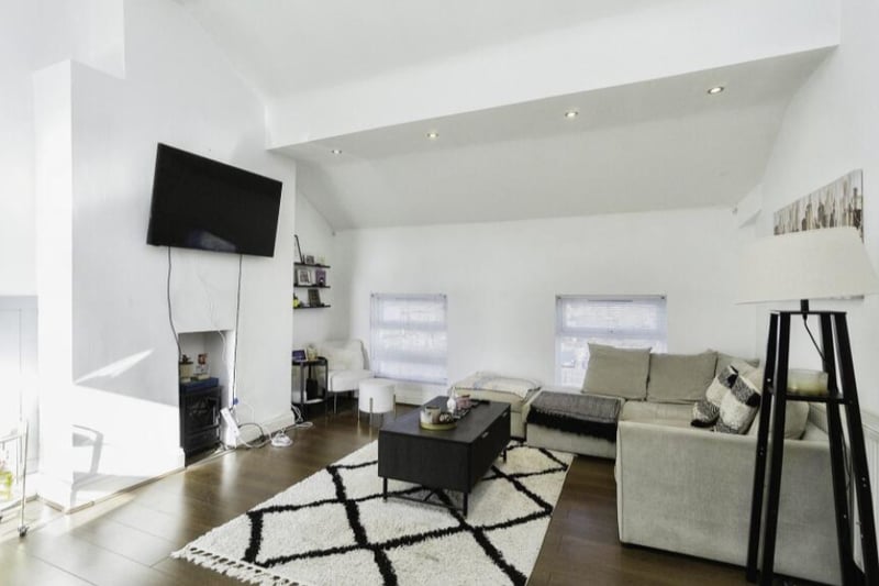 The living room features lovely high ceilings.