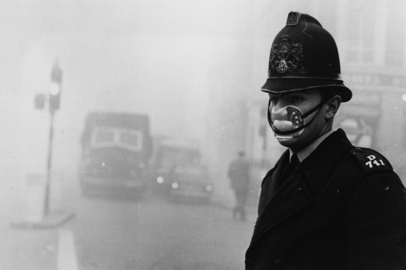 A London policeman wearing a mask for protection against the thick fog which hit most of the country and turned to smog in the city.