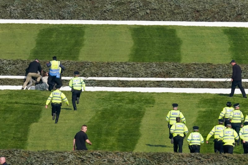 Activists try to disrupt the start of the race at Aintree Racecourse. 