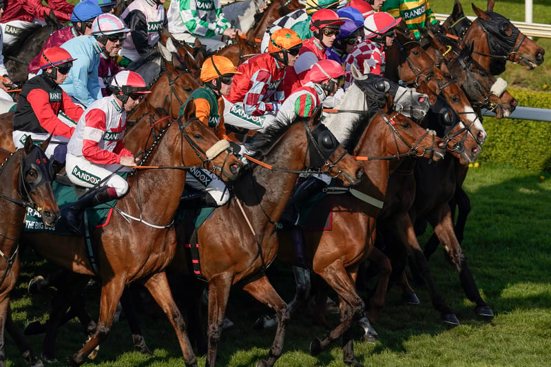 Runners line up at the start for The Randox Grand National Handicap Chase. 