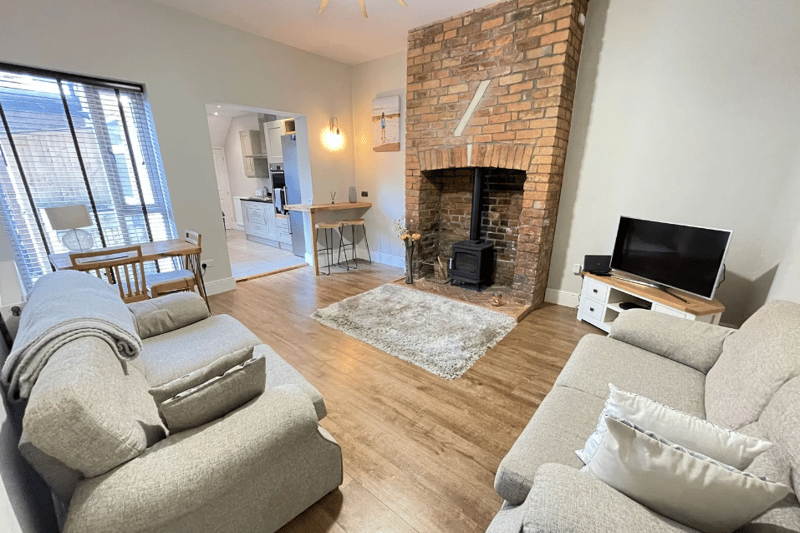 The main sitting room, with the exposed brick giving it a more modern feel