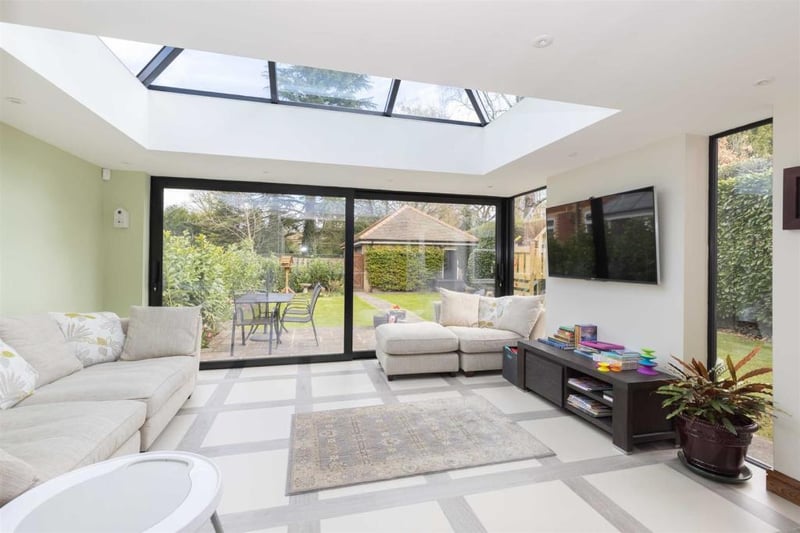 The living area with large glass doors and glass ceiling