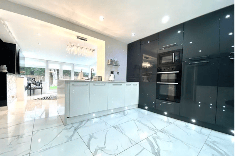 A modern open-plan kitchen, complete with stunning marble flooring and great views of the garden