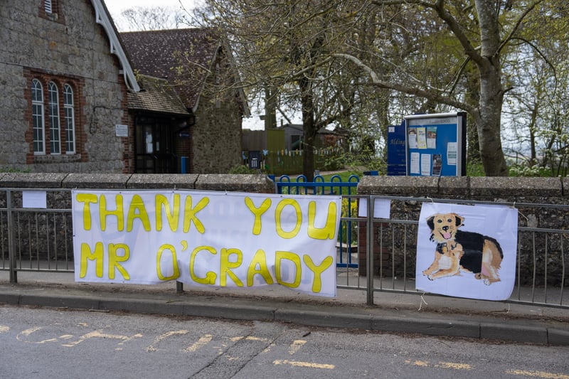 A  banner is displayed outside a school for the funeral cortege of Paul O'Grady