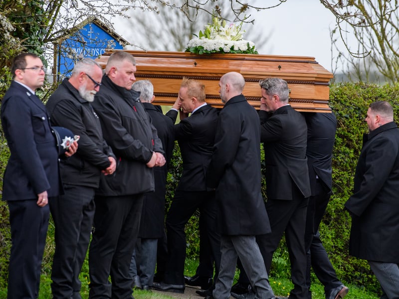 The coffin is carried into the church at the Funeral of Paul O'Grady