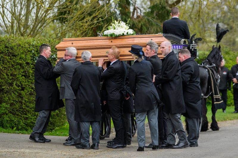 The coffin is carried into the church at the Funeral of Paul O'Grady