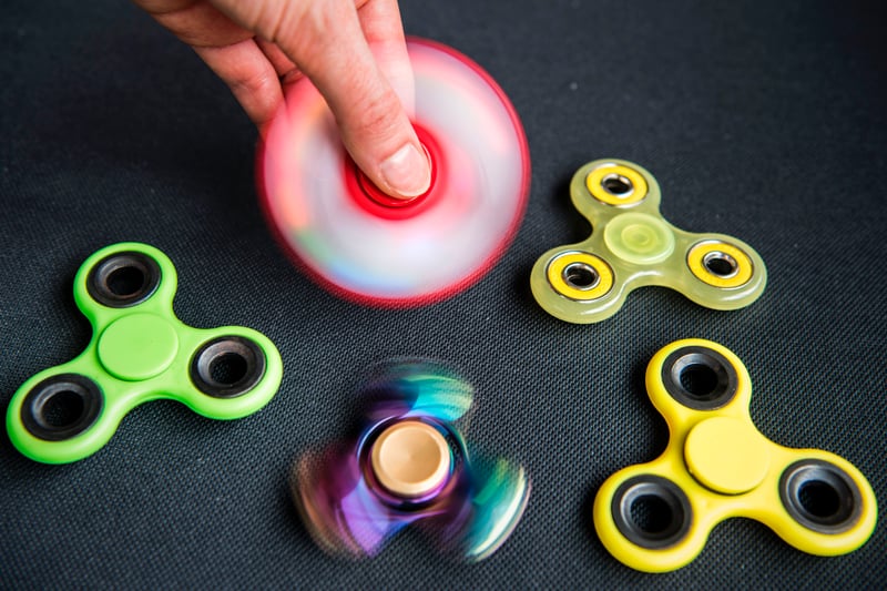 If you cast your mind back to the summer of 2017, you might just remember how fidget spinners were absolutely everywhere. Despite earlier variations of the toy existing as far back as 1993, it wasn’t until the late 2010s that fidget spinners blew up. Designed as a toy to help people who fidget, they were suddenly everywhere you looked in 2017. 