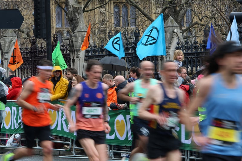 Extinction Rebellion along the marathon route. The Lonodn Marathon coincides with The Big One protests. (Photo by Susannah Ireland/AFP via Getty Images)