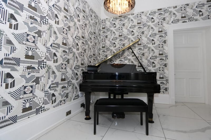 The beautiful piano which can be found in the hallway. 