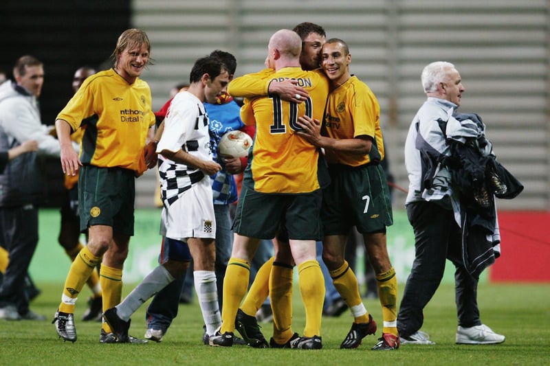 Chris Sutton, John Hartson and Henrik Larsson embrace each other after the win with a happy Johan Mjallby looking on.