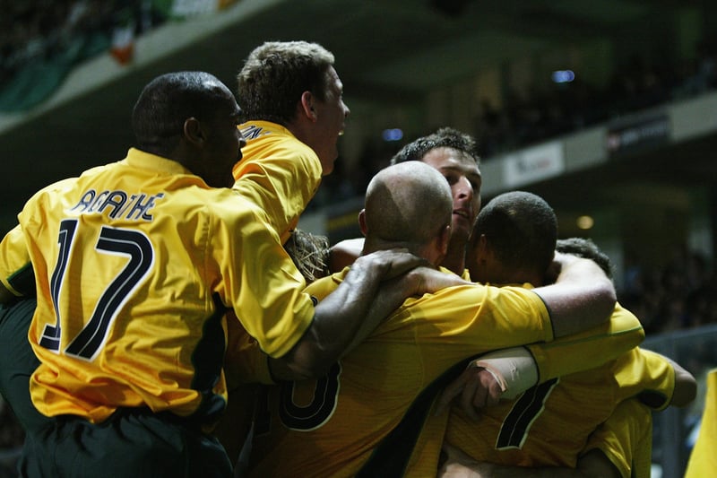 The Celtic players embrace Henrik Larsson after taking the lead on the night. 