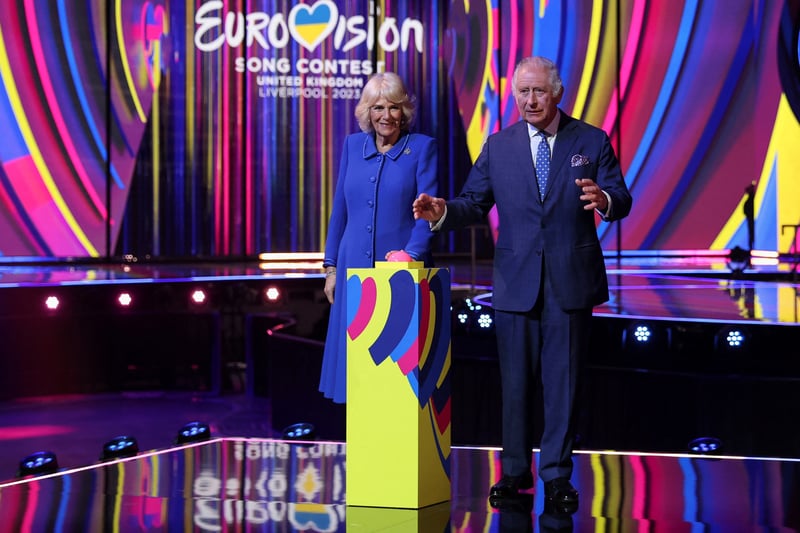 King Charles III and Camilla, Queen Consort react after switching on stage lighting as they visit the host venue of this year’s Eurovision Song Contest.k