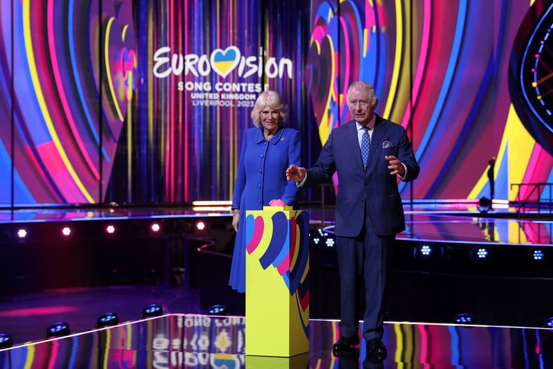 King Charles III and Camilla, Queen Consort react after switching on stage lighting as they visit the host venue of this year’s Eurovision Song Contest, the M&S Bank Arena.