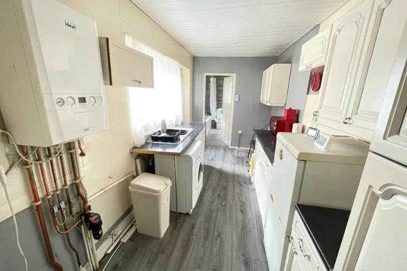 The kitchen on the property requires some work but features a range of wall and base units as well as an electric oven.