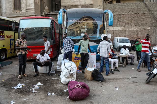 Sudanese people wait at a bus stop in downtown Cairo. Credit: Getty