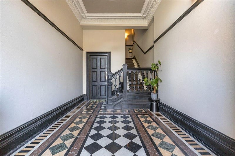 Grand communal ground floor hallway with original marble floor and magnificent ballustraded original stairway leading up to the second floor. 